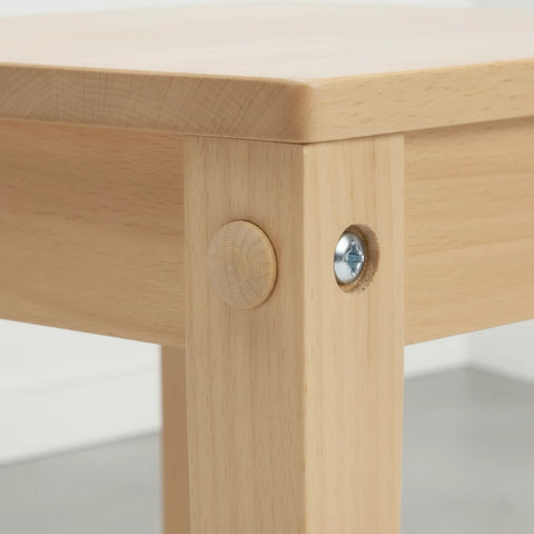 Wooden mushroom button plug covering screw holes in furniture